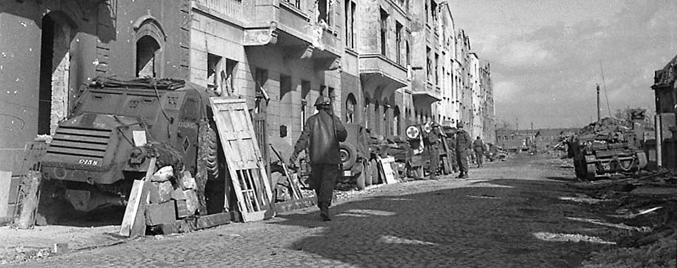 May be a black-and-white image of 3 people, people standing and street