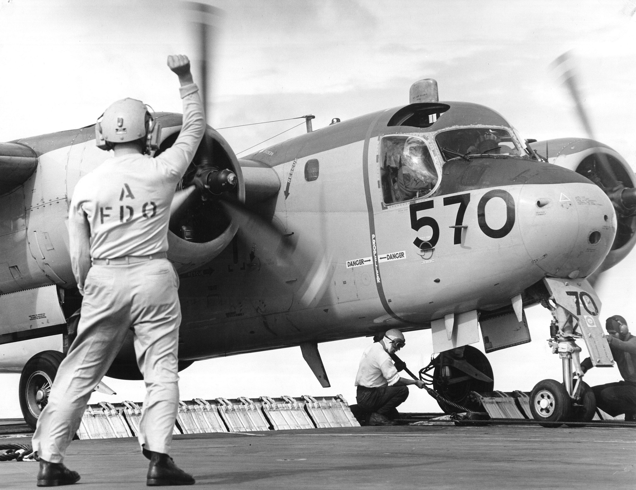 May be an image of 2 people, aircraft and text that says 'A FFDO DANCER DANGER 570 ٣'